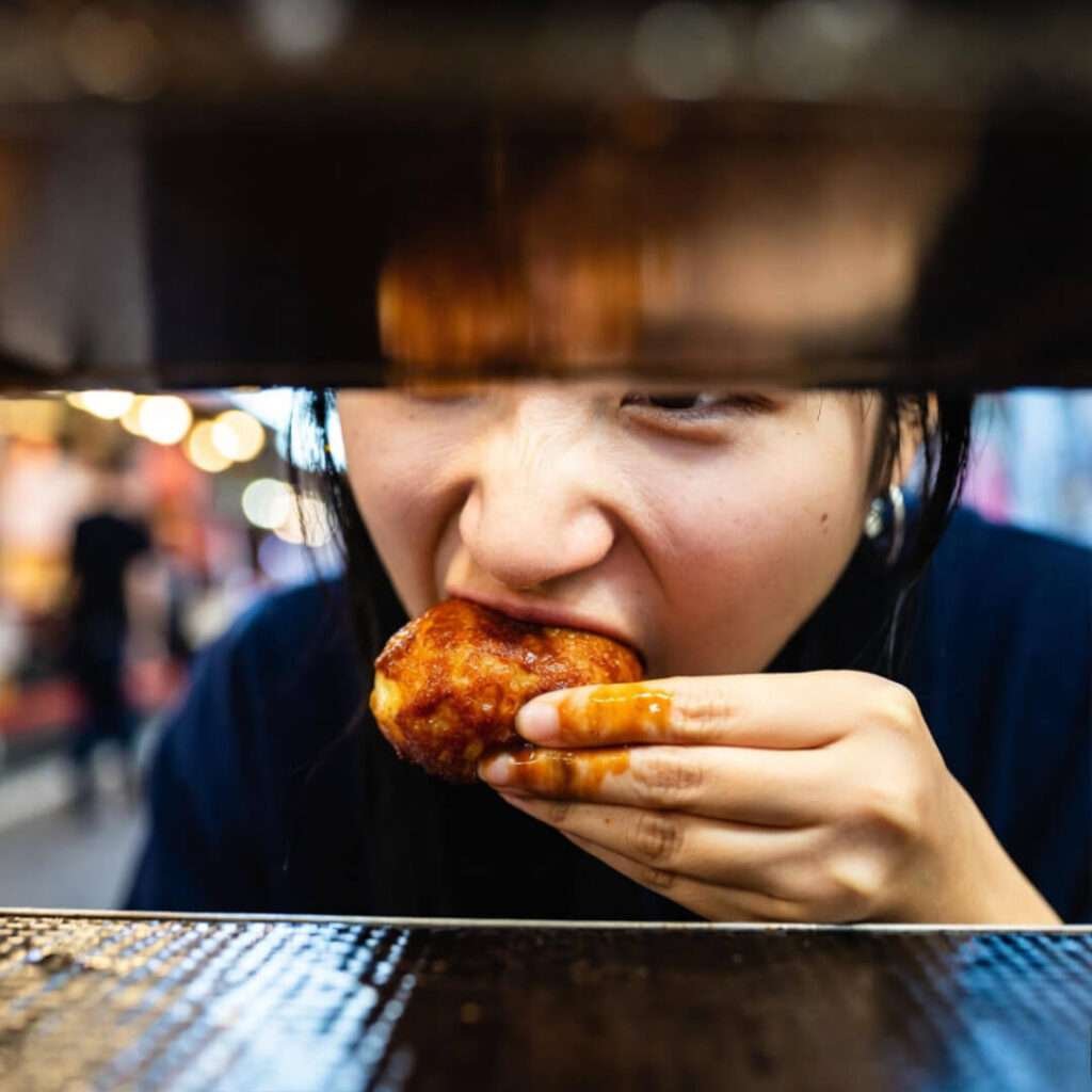 Takoyaki bite, saucy thumb.
