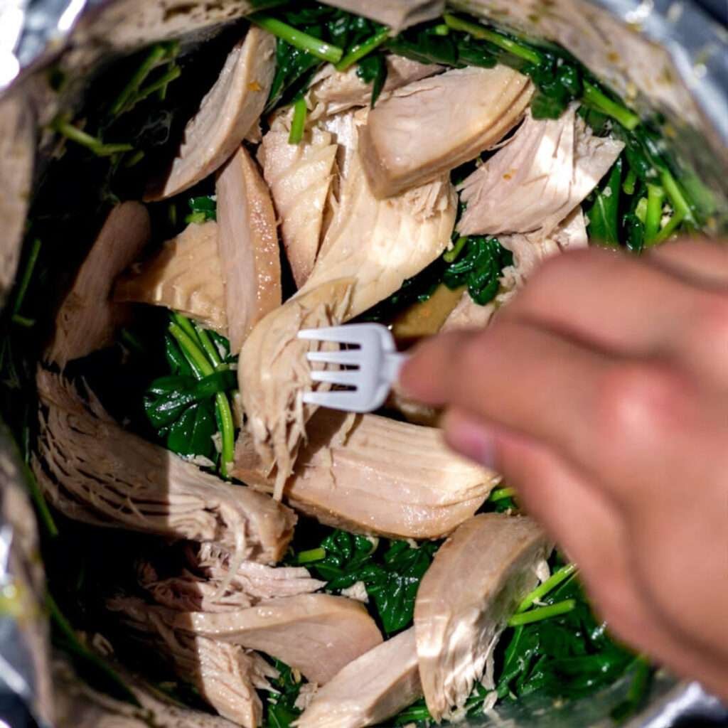 Sad tuna pouch dumped on spinach, caveman fork