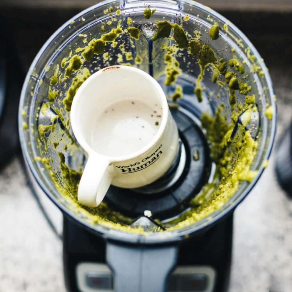 Messy blender with “World’s Okayest Human” mug waiting.