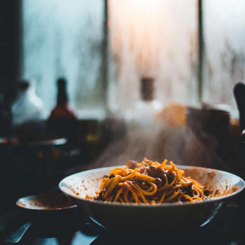 Steamy pasta through foggy window.