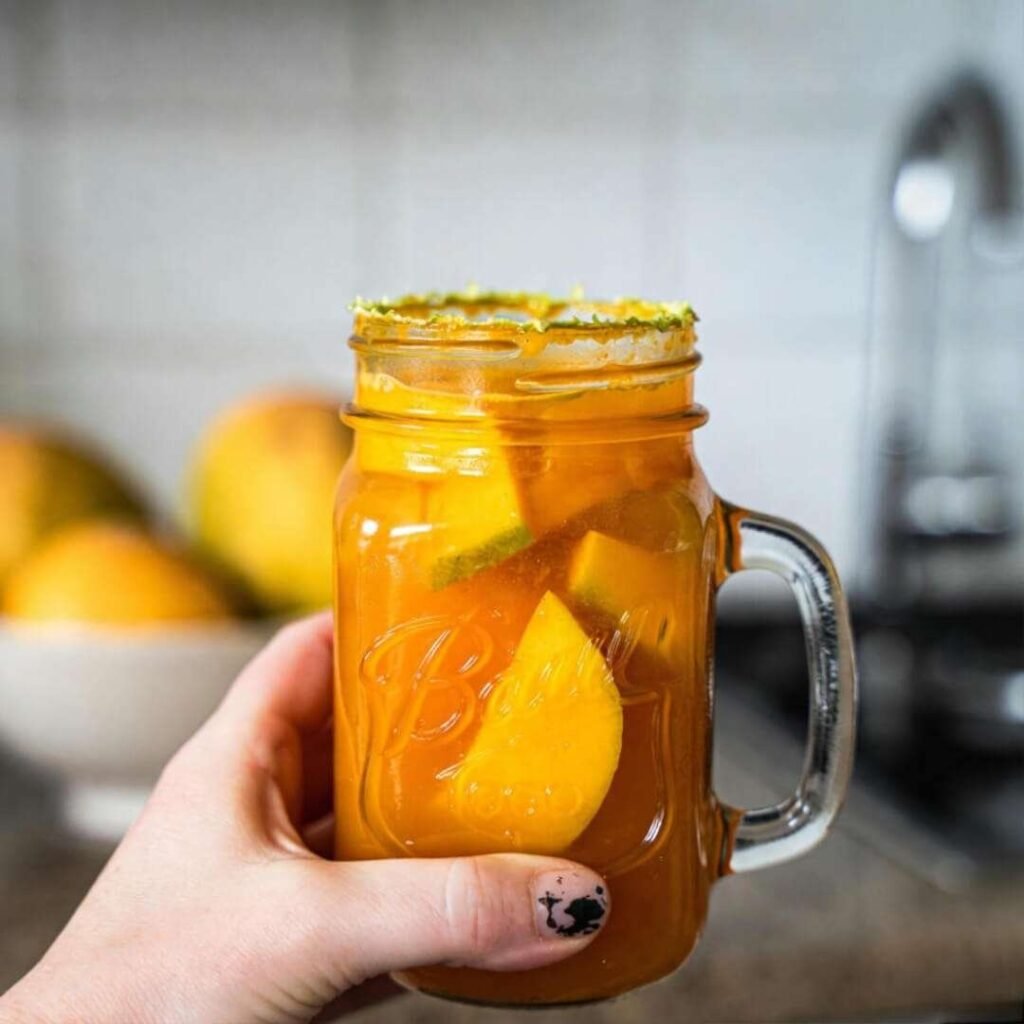 mango mocktail from my actual kitchen counter—there’s a ring of dried lime juice, one rogue mango chunk stuck to the side